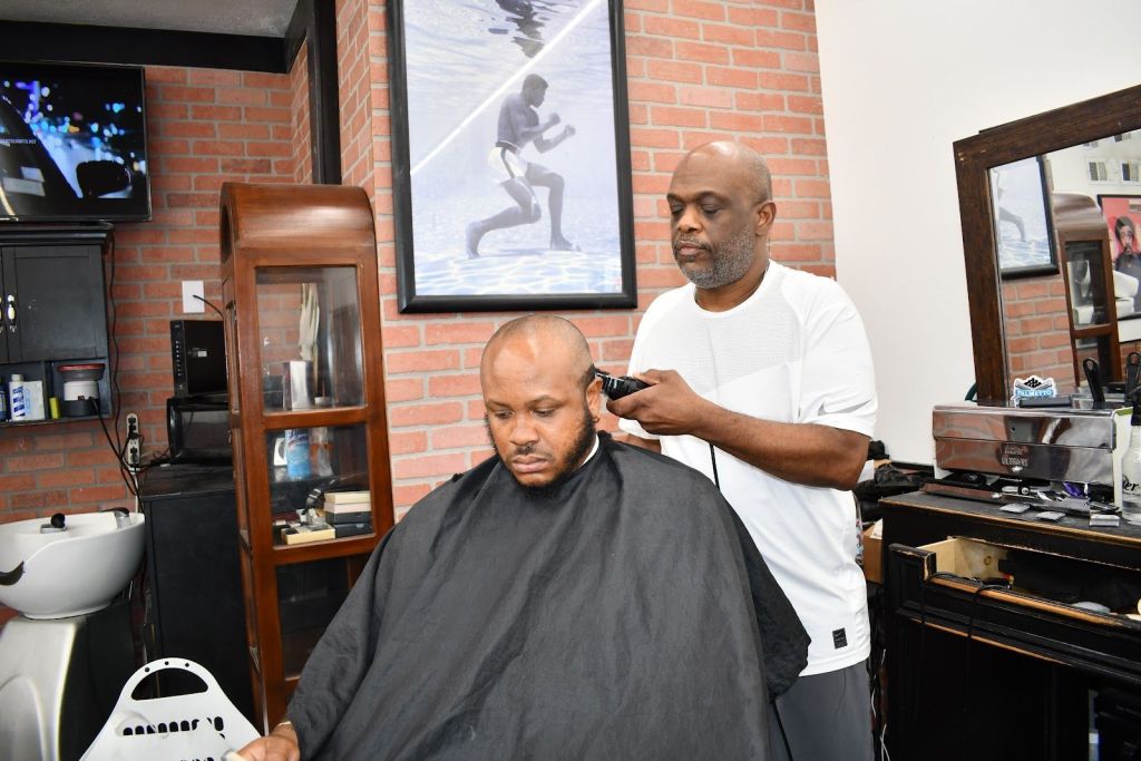 Barber Eric Eason cutting heads at Midtown Barbershop.